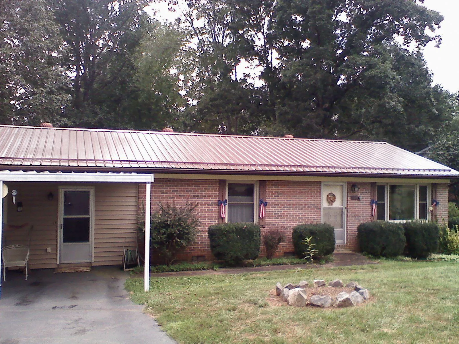 Bronze metal roof and carport on a brick ranch home — Roof Repair work by our crew in Chester
